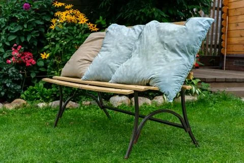 Old pillows dry on the bench. Stock Photos