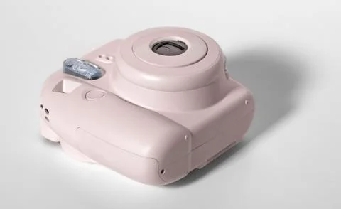 Old pink plastic camera on a white background. Stock Photos