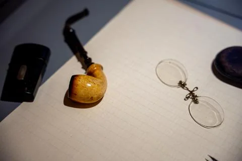 Old pipe, glasses and a notebook Stock Photos
