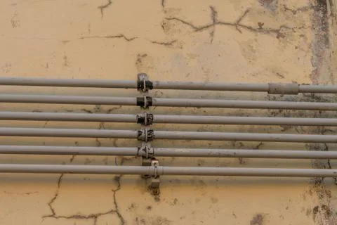 Old pipes on outside of wall Stock Photos