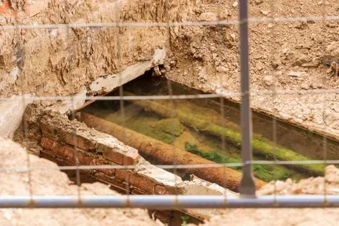 Old pipes in the pit Stock Photos