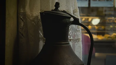 Old pitcher stands on a windowsill in a cafe closeup Stock Footage 97415776