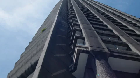 Old plane flying over Brutalist London City Architecture Stock Footage 337296479