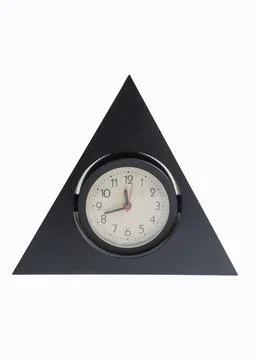 Old plastic black clock in the shape of a pyramid, isolated on a white backgroun Stock Photos