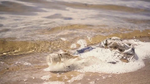 Old plastic bottle on the beach. Slow mo Video stock 76354622
