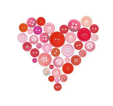 Old plastic buttons in a heart shape isolated on white Fotos de archivo