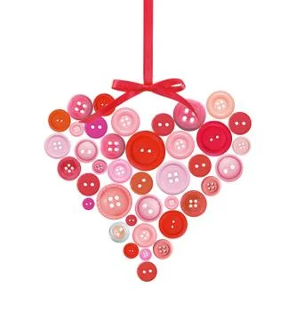 Old plastic buttons in a heart shape isolated on white Foto stock
