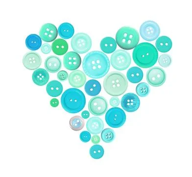 Old plastic buttons in a heart shape isolated on white Fotos de archivo
