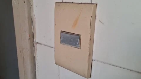 Old plastic light switch mounted on white tiled wall video clip Stock Footage 339248178