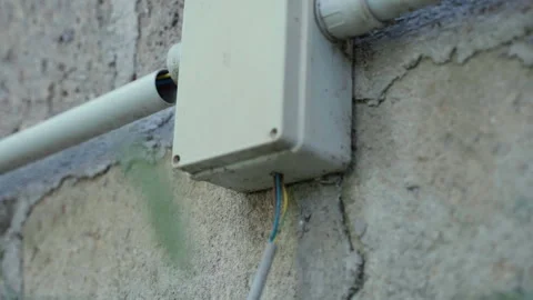 Old plastic power supply box with red, blue and yellow cables hanging from the 스톡 동영상 296803202