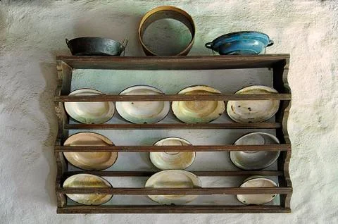 Old plates on a wall in a kitchen Stock Photos
