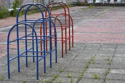 Old playground climbing frames on an abandoned paved area Foto stock
