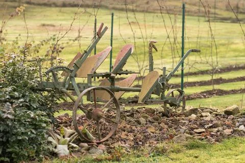An old ploughing tool. Two-row rotary plough for ploughing. Background of a.. Stock Photos