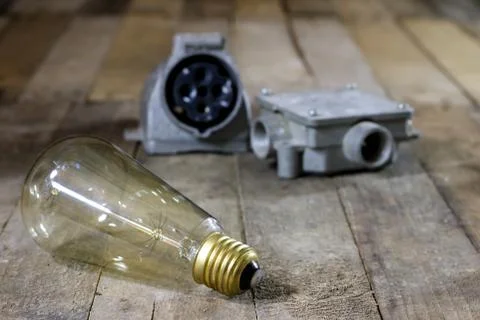 Old plug and socket high voltage. Old electrical accessories. Wooden table. Stock Photos