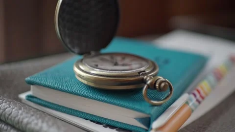 Old pocket watch on a notebook and colorful pen Stock Footage 328271163