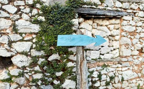 Old pointer to the right on a background of a stone wall Stock Photos