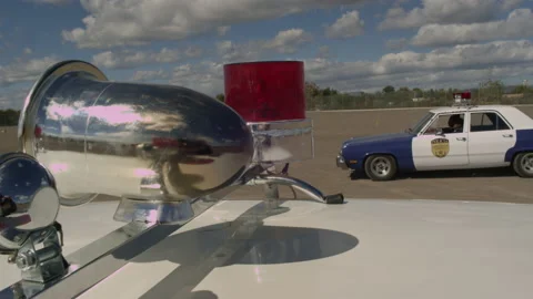 Old police car siren during a chase, rotating and blinking during the day. Stock Footage