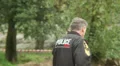 Old policeman walks walky talky radio answers emergency call HD Footage