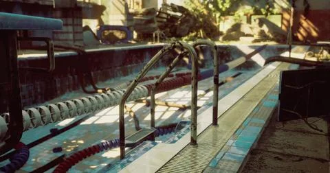 Old pool with worn steps and overgrown surroundings in afternoon light Stock Illustration