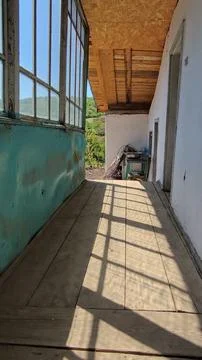 Old porch . Dramatic window shadows on a weathered, rustic wooden deck Stock Photos