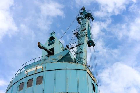 Old port crane for loading cargo onto sea vessels. Stock Photos