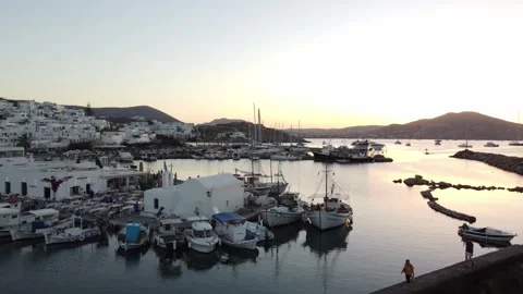 Old port of Naousa at sunset overlooking Aegean Sea, Greek Island, Drone shot Stock Footage 336413950
