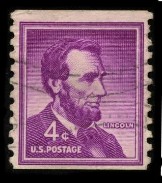 Old postage stamp on a black background. Stock Photos