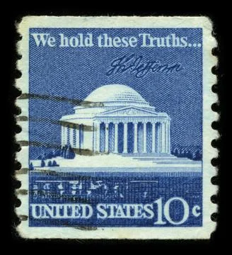 Old postage stamp on a black background. Stock Photos