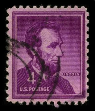 Old postage stamp on a black background. Stock Photos