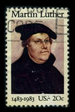 Old postage stamp on a black background. Stock Photos
