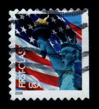 Old postage stamp on a black background. Stock Photos