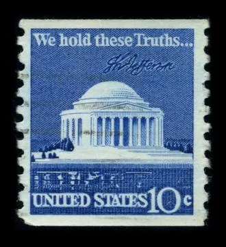 Old postage stamp on a black background. Stock Photos