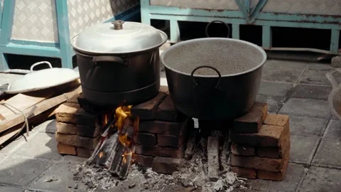 Old pot standing on wood burning stove with steam Stock Footage 210865007