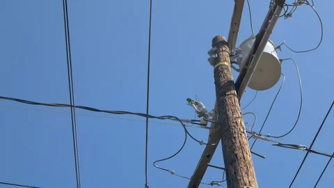 An Old Power Line Pole with Holes and Moving Wires Stock Footage