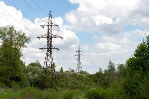 Old power lines against backdrop of nature in summer, Russia Stock Photos