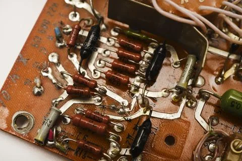 An old printed circuit board with microelements. Semiconductor elements in .. Stock Photos