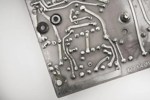 An old printed circuit board with microelements. Semiconductor elements in .. Stock Photos