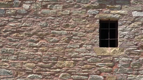 Old prison stone wall and window with bars Stock Footage 65342030