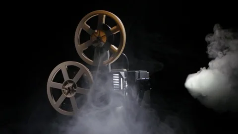 Old projector showing film in the smoke.... | Stock Video | Pond5