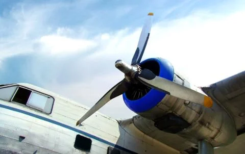 Old propeller airplane engine against cloudy blue sky Stock Photos