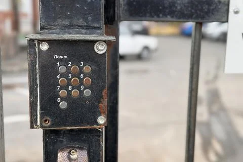 An old push-button intercom named firm POLIS in Russian words installed on the Stock Photos