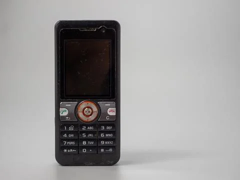 Old push button mobile phone. Broken phone. Stock Photos