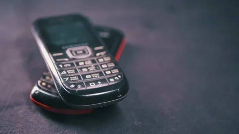Old Push Button Mobile Phones Stacked On Dark Textured Background Stock Footage 330110466