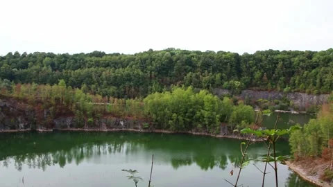 Old quarry lake or old mining pit was closed and flooded with freshwater Stock Footage 343871951