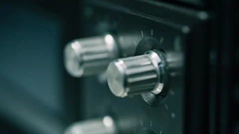 Old radio receiver panel in dark place closeup. Volume balance knobs on recorder Stock-Footage 332363264