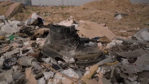 Old ragged boot in the trash35 5 Stock Footage 127430131
