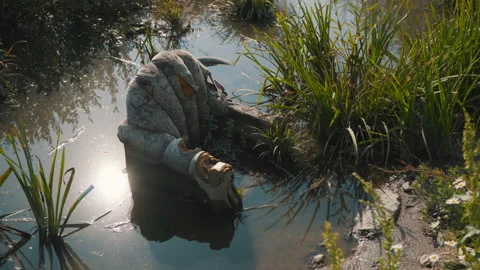 The old ragged sofa was drowned in the lake Stock Footage 146805927