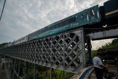  OLD RAILROAD BRIDGE IN WEST JAVA A train passes the Cirahong bridge in Ci... Photos