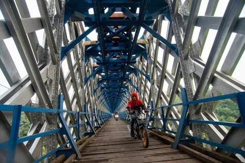  OLD RAILROAD BRIDGE IN WEST JAVA Motorcyclists cross the Cirahong bridge ... Photos