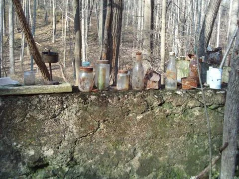 Old Railroad Path Old bottles on Wall in the woods Stock Photos